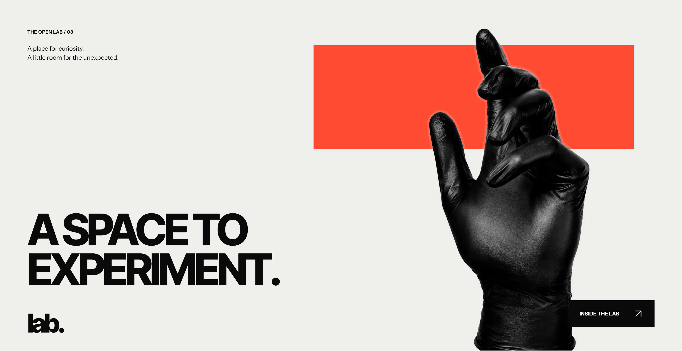 LAB’s experimental studio section, combining a sculptural black glove, expressive typography and an orange-red field.